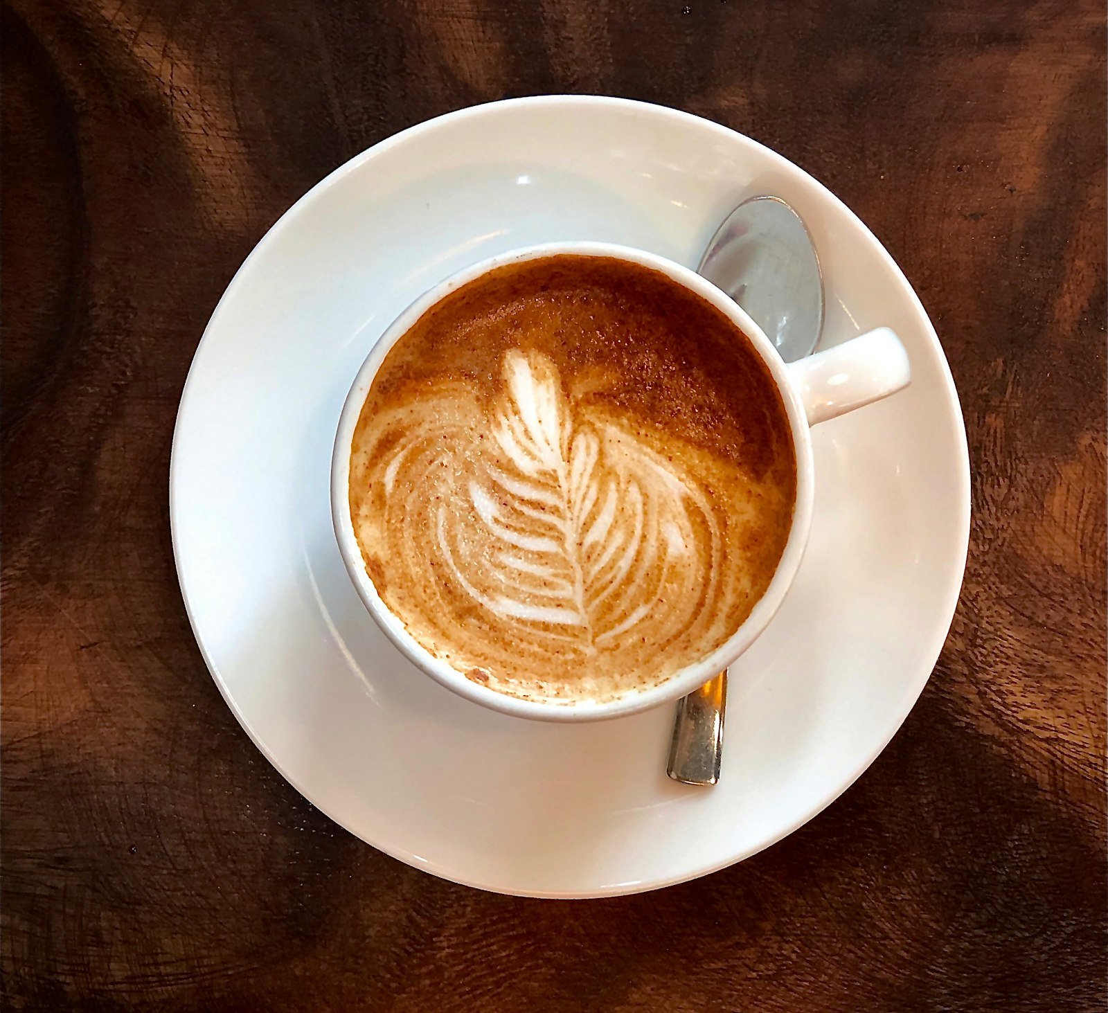 A cappuccino with delicate latte art in a ceramic cup.