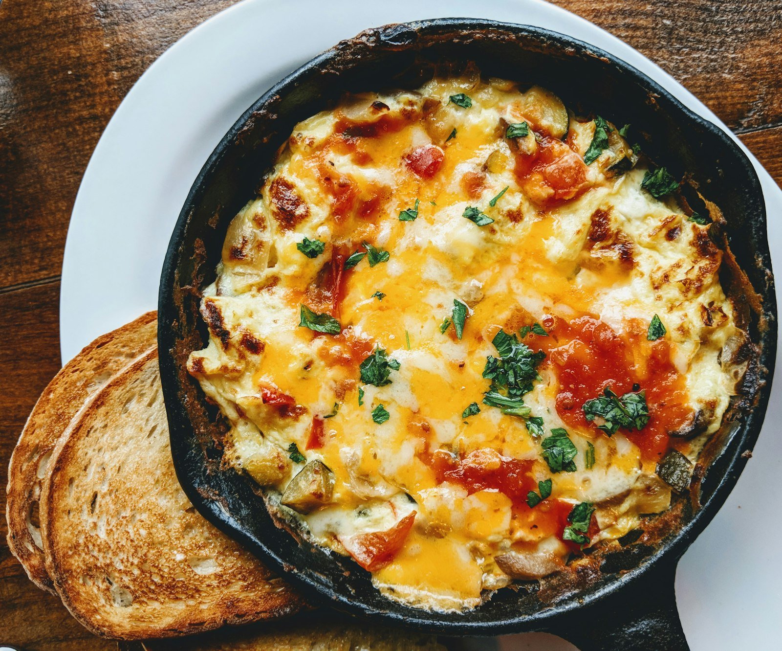 Folded omelette with herbs and toast.